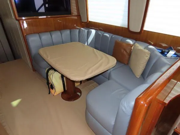 Slide: The Image of Luxurious seating area in a 2009 Viking 64 Convertible yacht with a cushioned table. - 34