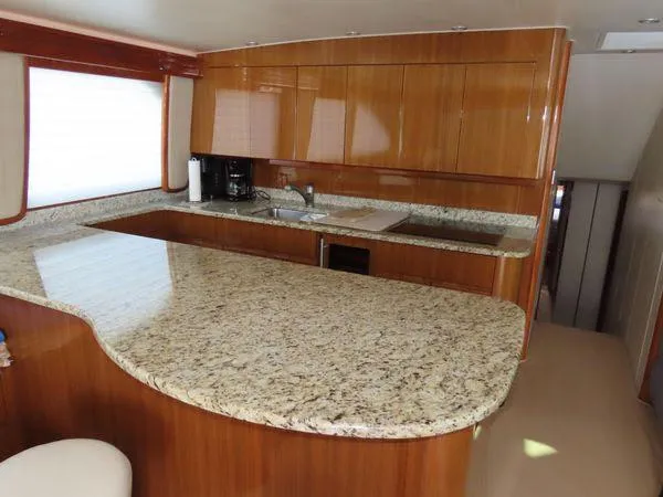 Slide: The Image of Luxurious kitchen interior of 2009 Viking 64 Convertible yacht with granite countertops. - 36
