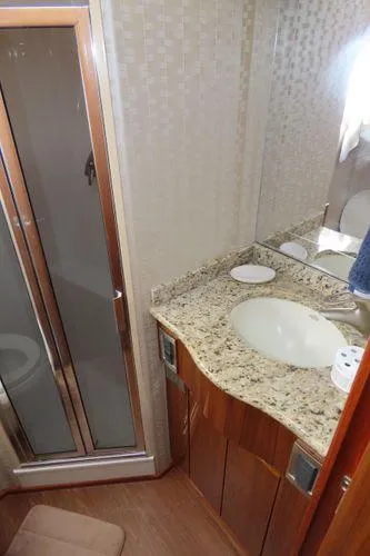 Slide: The Image of 2009 Viking 64 Convertible yacht bathroom with granite countertop and shower. - 40