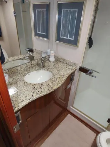Slide: The Image of Luxurious bathroom in 2009 Viking 64 Convertible yacht with granite countertop and modern fixtures. - 42