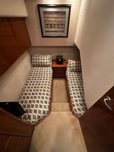 Slide: The Image of 2009 Viking 64 Convertible cabin with twin beds and elegant decor. - 44