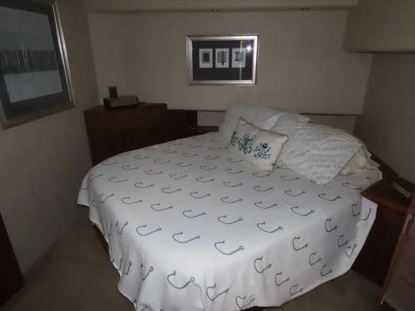 Slide: The Image of Bedroom interior of 2009 Viking 64 Convertible yacht with nautical-themed bedding. - 45