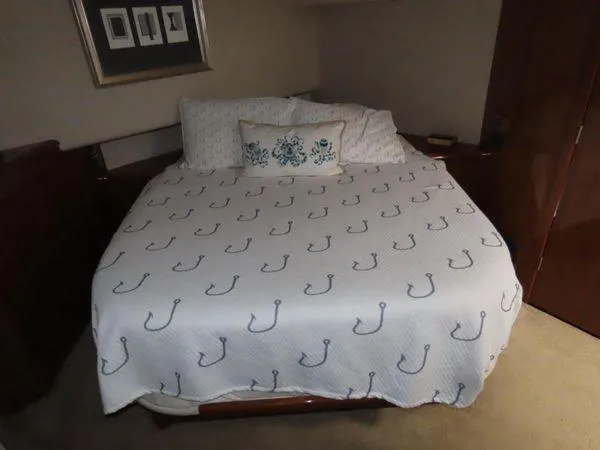 Slide: The Image of Cozy bedroom in 2009 Viking 64 Convertible yacht with anchor-patterned bedding. - 46