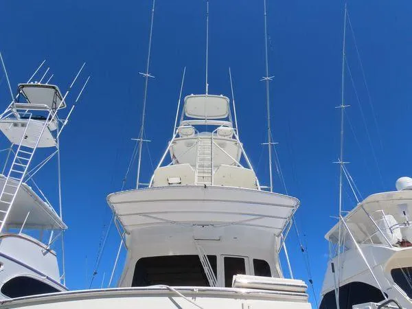 Slide: The Image of 2009 Viking 64 Convertible yacht with tall antennas against a clear blue sky. - 6