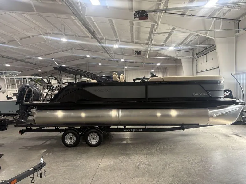 The Image of 2025 Godfrey Sweetwater 2286 SFLC pontoon boat in showroom, featuring 27" iMPACT Center Tube Package. - 1