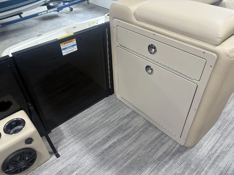 Slide: The Image of Interior of 2025 Godfrey Sweetwater 2286 SFLC boat, featuring storage compartments and cup holders. - 12