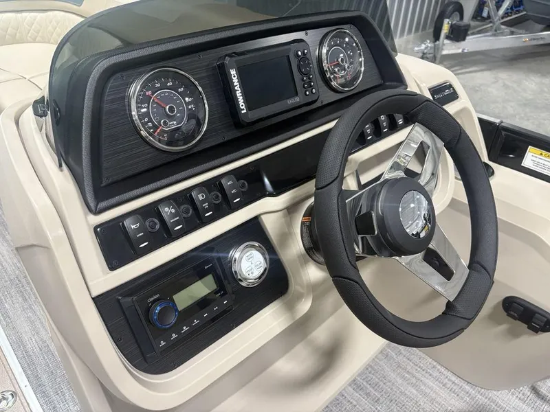 Slide: The Image of Dashboard of 2025 Godfrey Sweetwater 2286 SFLC boat with steering wheel and control panel. - 21