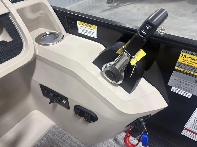 Slide: The Image of Control panel of 2025 Godfrey Sweetwater 2286 SFLC boat with throttle and safety warnings. - 25