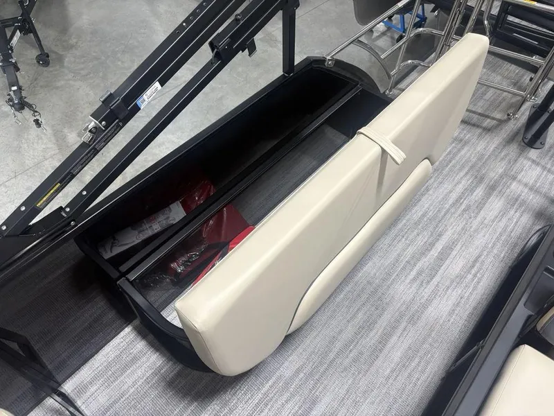Slide: The Image of Open storage compartment in 2025 Godfrey Sweetwater 2286 SFLC boat with beige seating. - 28