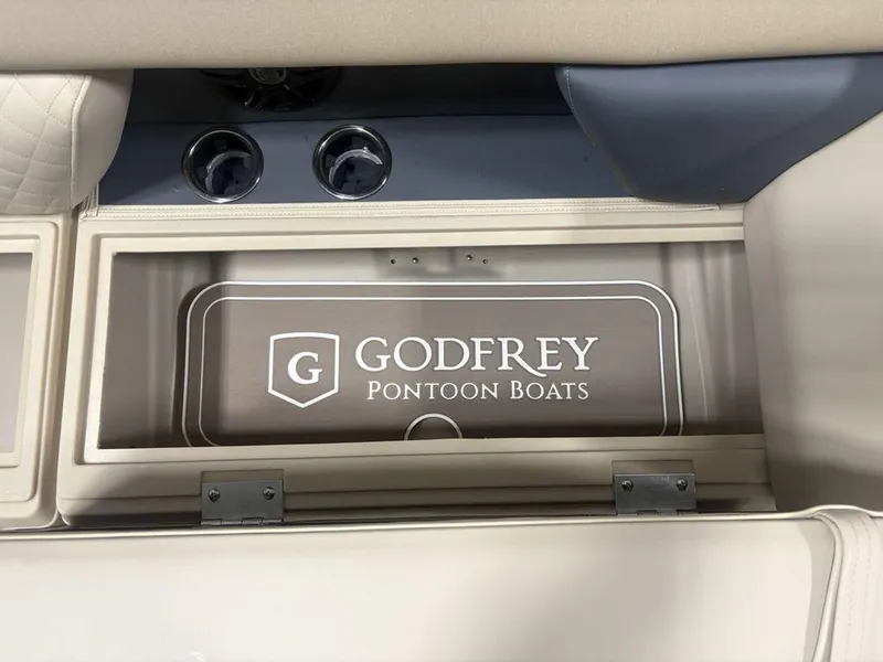 Slide: The Image of Interior of 2025 Godfrey Sweetwater 2286 SFLC pontoon boat, featuring branded storage compartment. - 3
