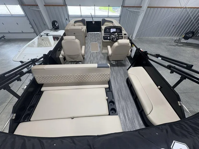 Slide: The Image of 2025 Godfrey Sweetwater 2286 SFLC pontoon boat interior with beige seating and modern dashboard. - 36