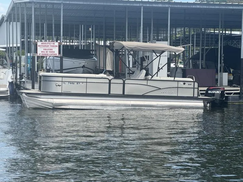 Slide: The Image of 2019 Manitou 250 SHP pontoon boat docked with Suzuki outboard motor. - 3