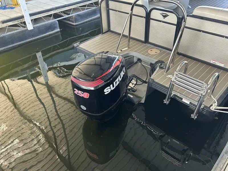 Slide: The Image of 2019 Manitou 250 SHP boat with Suzuki 250 outboard motor at dock. - 9