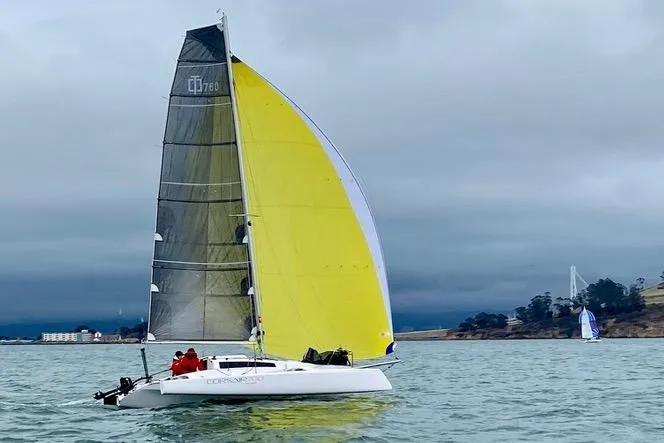 The Image of Sailboat Corsair 760 Dash 2018 with yellow sail on calm water, overcast sky. - 0