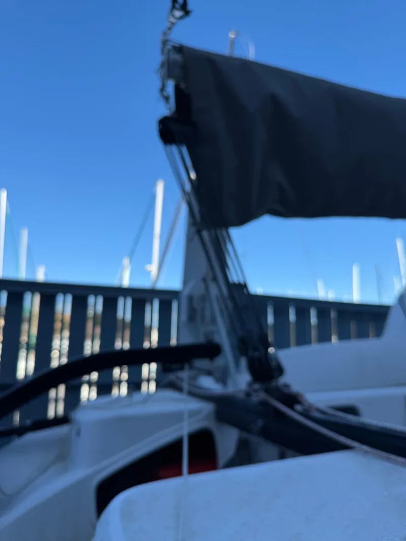 Slide: The Image of 2018 Corsair 760 Sport sailboat with rigging, docked under clear blue sky. - 14