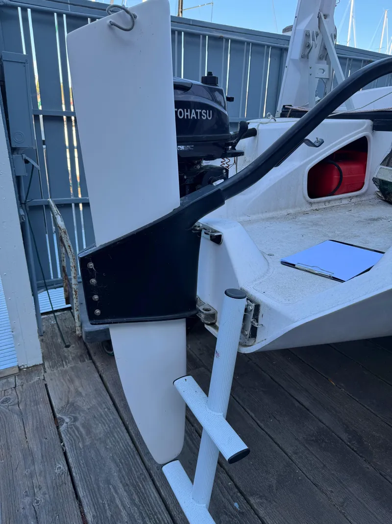 Slide: The Image of 2018 Corsair 760 Sport boat with Tohatsu motor, docked with visible rudder and ladder. - 6