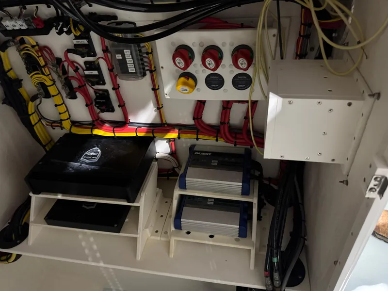 Slide: The Image of Electrical system inside 2023 Calypso Center Console boat, featuring organized wiring and control panels. - 11