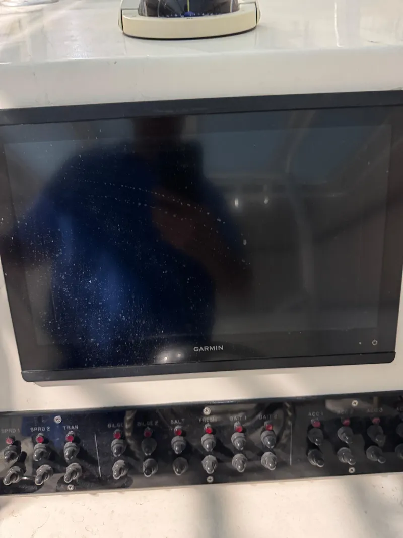 Slide: The Image of 2023 Calypso Center Console dashboard with Garmin display and control switches. - 12