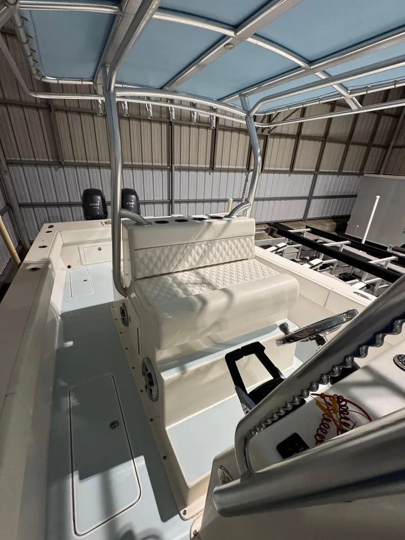 Slide: The Image of 2023 Calypso Center Console boat interior with cushioned seating and dual engines. - 17
