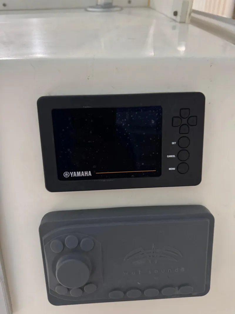 Slide: The Image of 2023 Calypso Center Console dashboard with Yamaha display and control panel. - 19