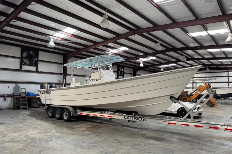 Slide: The Image of 2023 Calypso Center Console boat on trailer in warehouse setting. - 2