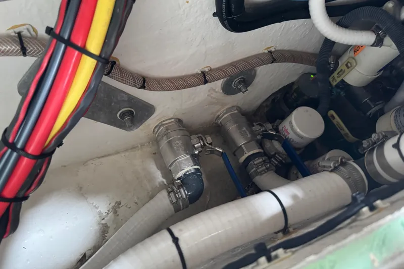 Slide: The Image of Engine compartment of 2023 Calypso Center Console with wiring and plumbing components. - 23