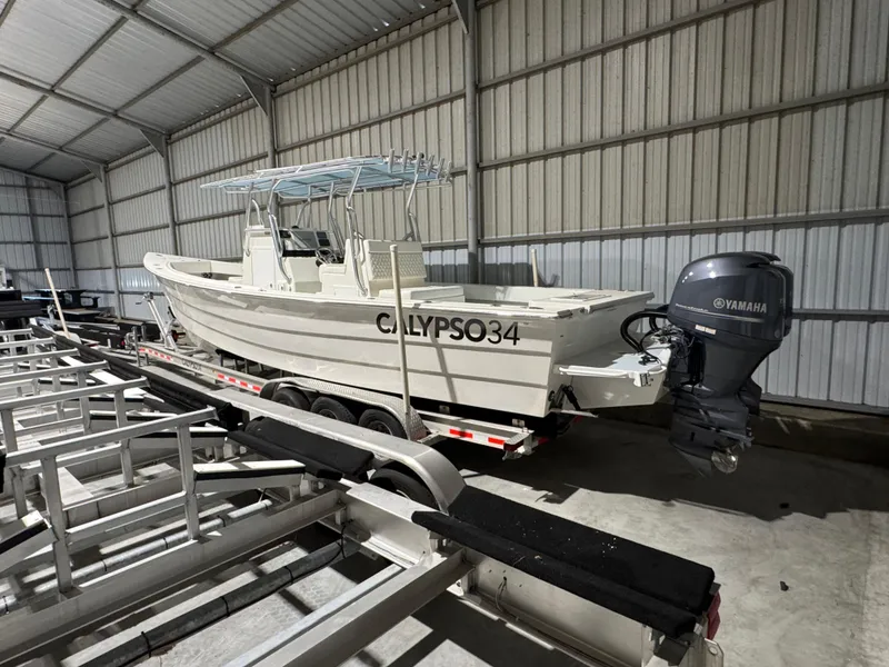 Slide: The Image of 2023 Calypso Center Console boat in storage, featuring Yamaha outboard motor. - 3