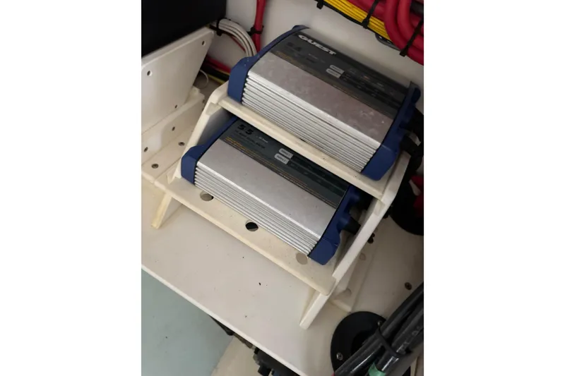 Slide: The Image of Dual battery chargers in 2023 Calypso Center Console boat, organized with wiring. - 31