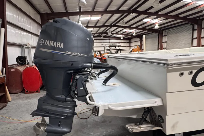 Slide: The Image of 2023 Calypso Center Console boat with Yamaha outboard motor in a warehouse. - 39