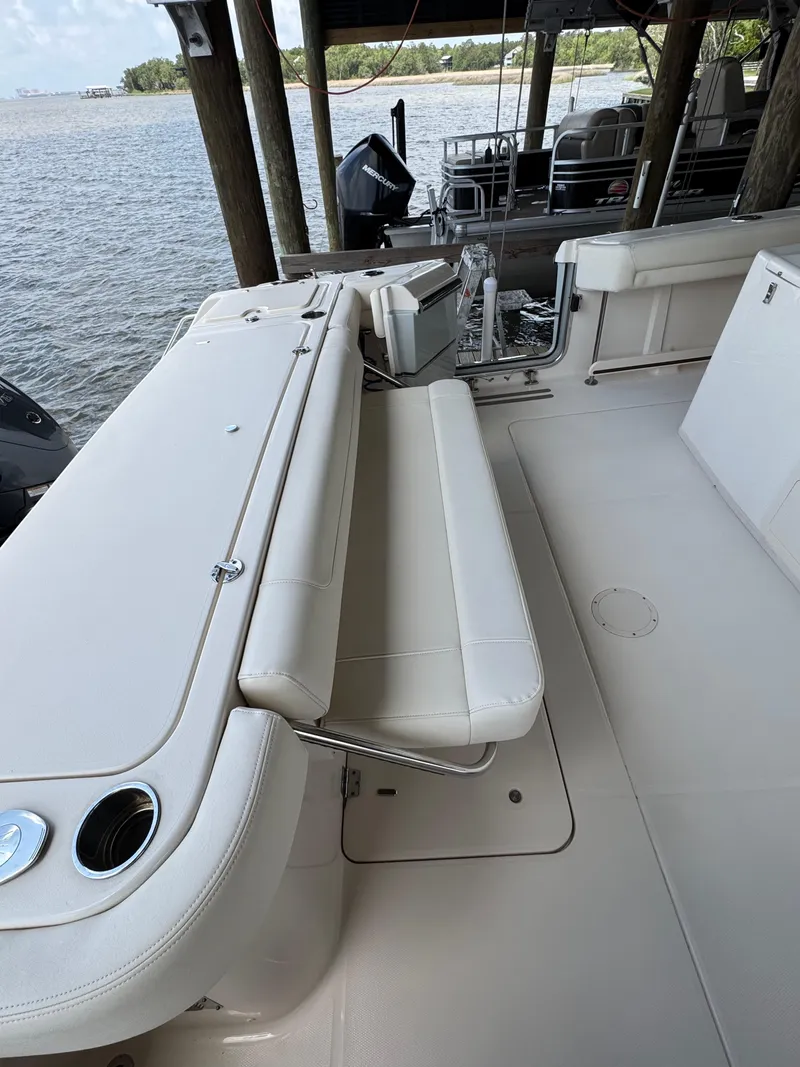 Slide: The Image of 2023 Calypso Center Console boat interior with white seating and cup holders. - 4