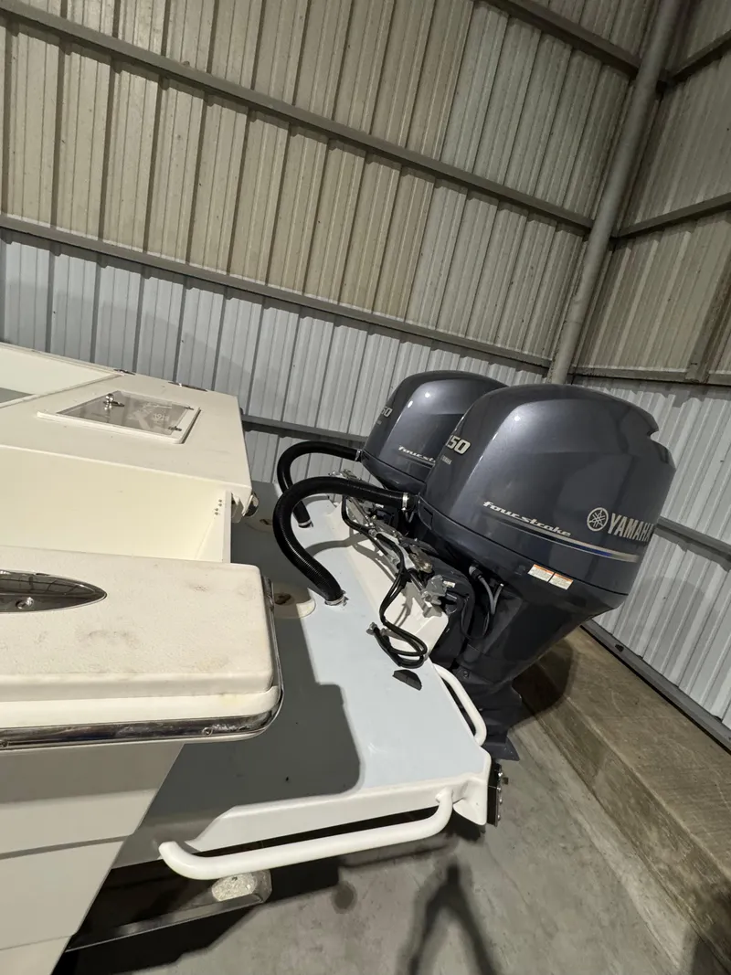 Slide: The Image of 2023 Calypso Center Console boat with dual Yamaha outboard motors in a storage facility. - 6