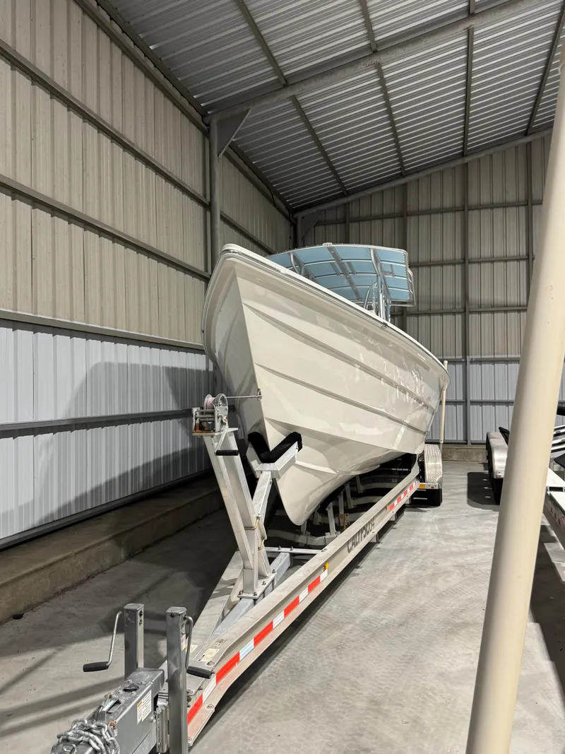 Slide: The Image of 2023 Calypso Center Console boat on trailer in storage facility. - 7