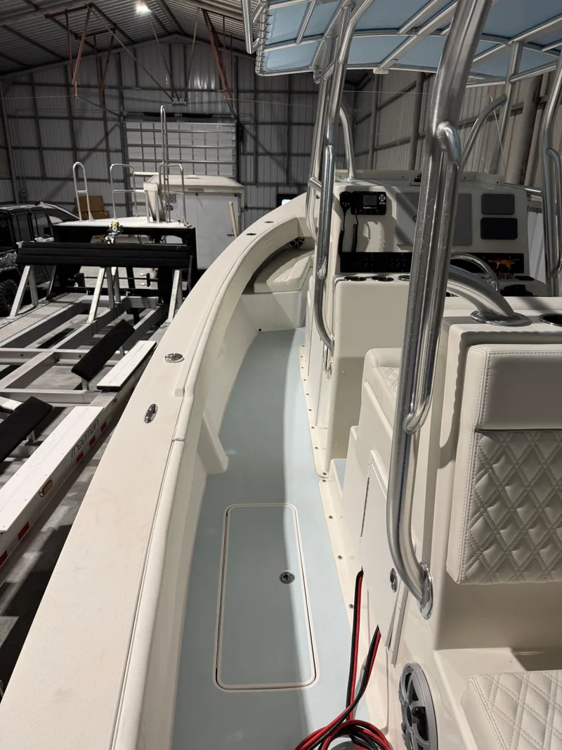 Slide: The Image of 2023 Calypso Center Console boat interior in a warehouse, featuring sleek design and modern amenities. - 9