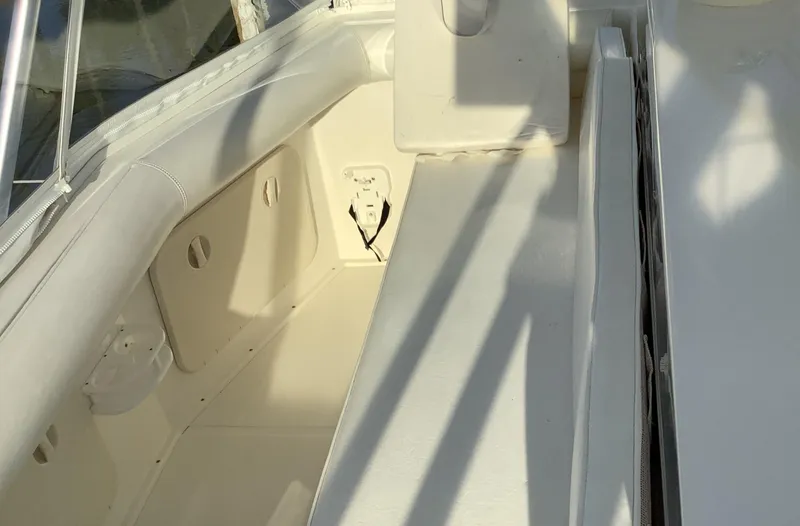 Slide: The Image of 2006 Cabo 35 Flybridge Sportfisher interior seating area with white upholstery. - 11