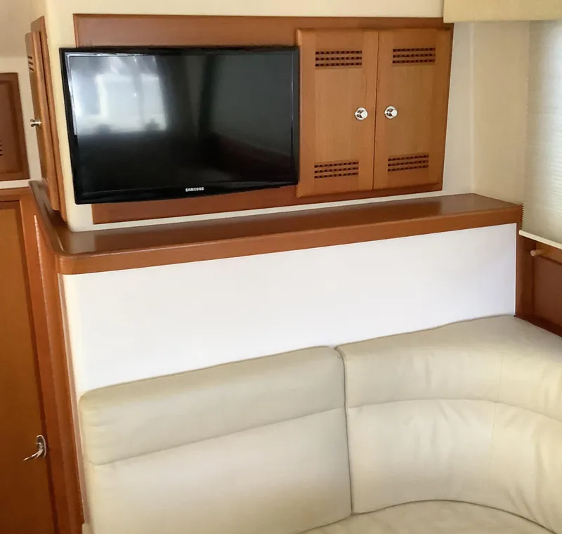 Slide: The Image of Interior of 2006 Cabo 35 Flybridge Sportfisher with TV and beige seating. - 21