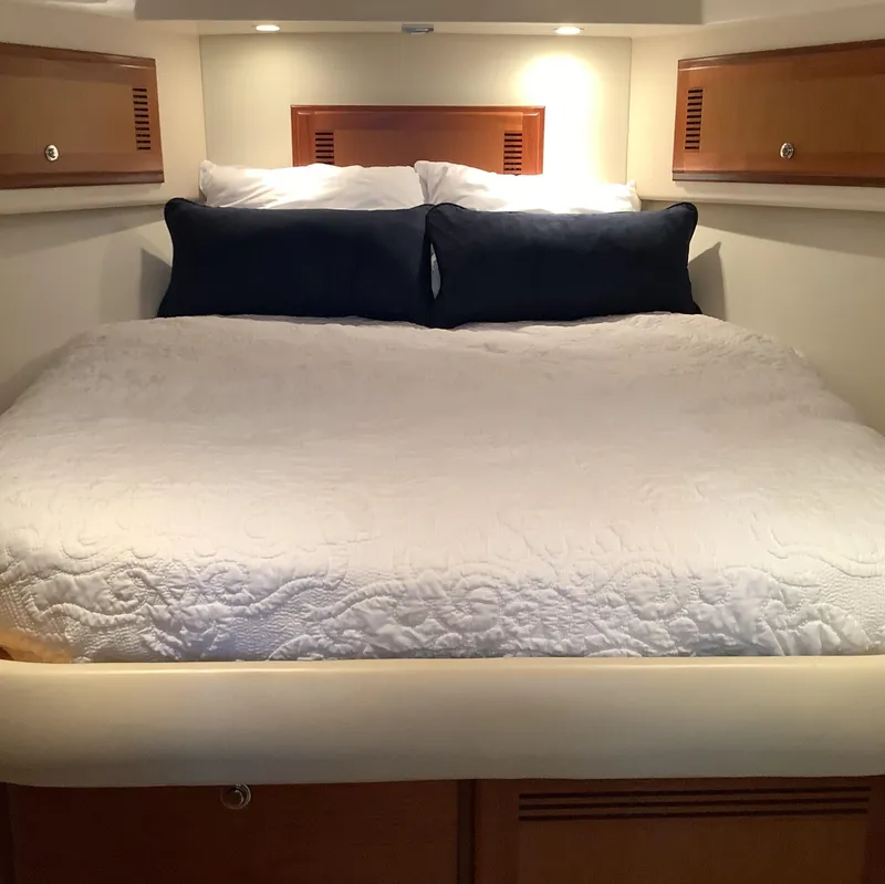 Slide: The Image of Luxurious cabin interior of 2006 Cabo 35 Flybridge Sportfisher with cozy bedding. - 25