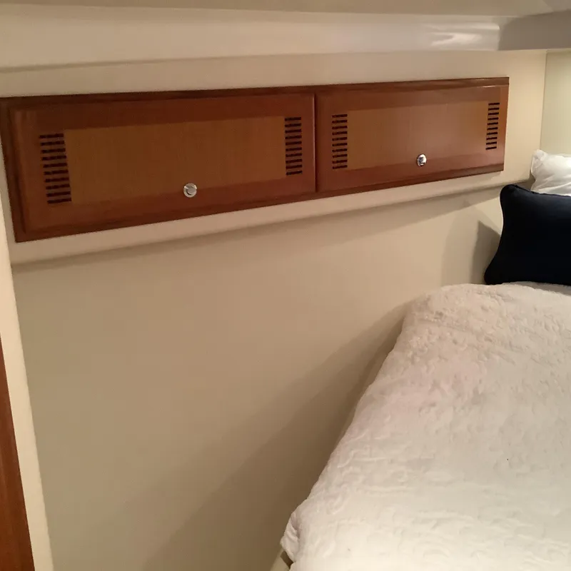 Slide: The Image of Interior cabin of 2006 Cabo 35 Flybridge Sportfisher with wooden storage and bedding. - 28