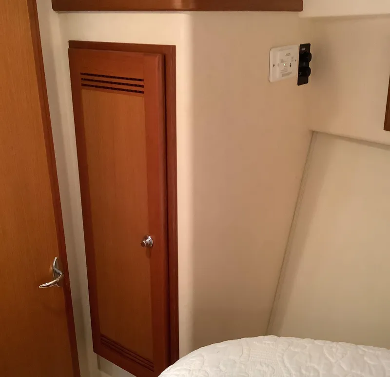 Slide: The Image of Interior of 2006 Cabo 35 Flybridge Sportfisher, featuring wooden cabinet and control panel. - 30