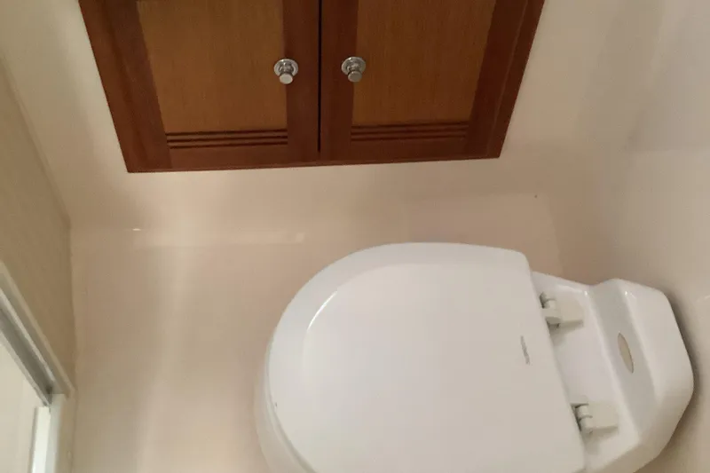 Slide: The Image of Bathroom interior of 2006 Cabo 35 Flybridge Sportfisher with wooden cabinet and toilet. - 33