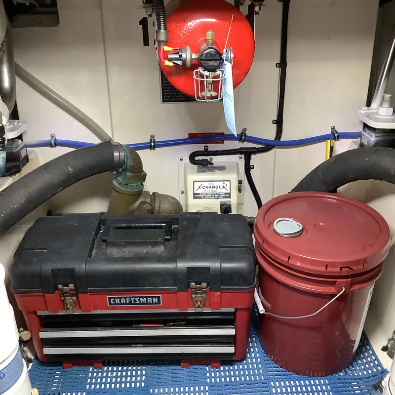 Slide: The Image of Engine room of 2006 Cabo 35 Flybridge Sportfisher with toolbox and red bucket. - 36