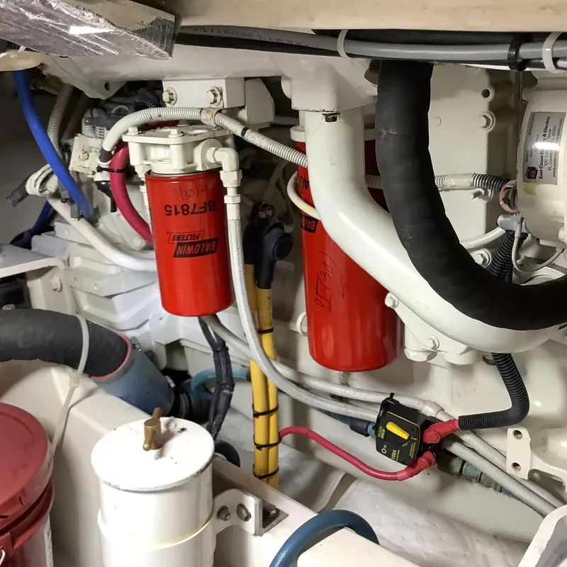 Slide: The Image of Engine room of a 2006 Cabo 35 Flybridge Sportfisher with visible filters and wiring. - 38