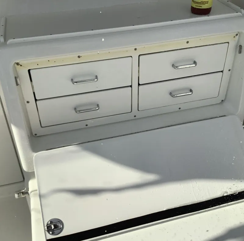 Slide: The Image of 2006 Cabo 35 Flybridge Sportfisher storage drawers and compartment detail. - 6