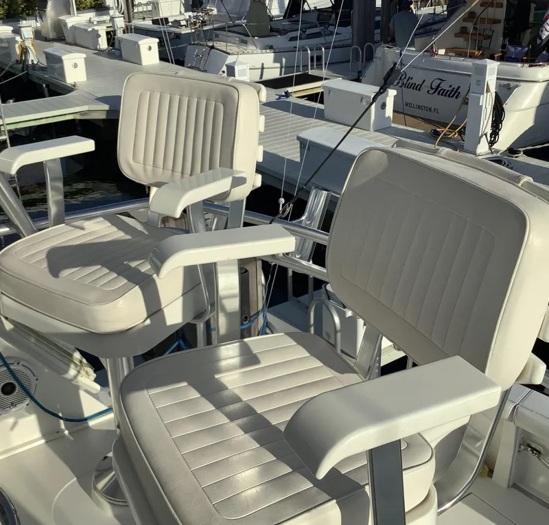 Slide: The Image of Two cushioned seats on a 2006 Cabo 35 Flybridge Sportfisher boat at a marina. - 8