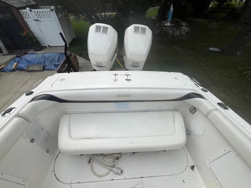 Slide: The Image of 2000 Wellcraft 302 SCARAB SPORT boat with dual outboard engines, white interior. - 10