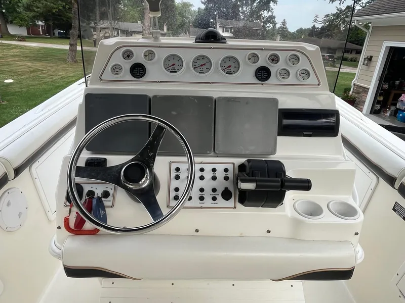 Slide: The Image of Console of a 2000 Wellcraft 302 SCARAB SPORT boat with steering wheel and gauges. - 14