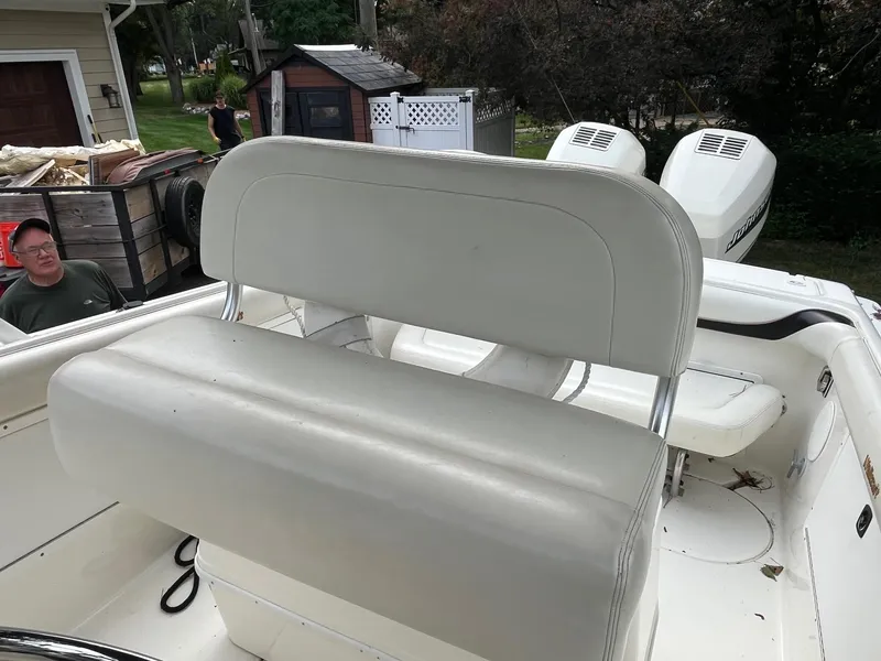 Slide: The Image of 2000 Wellcraft 302 SCARAB SPORT boat interior with white seating and dual outboard engines. - 15
