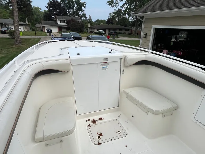 Slide: The Image of 2000 Wellcraft 302 SCARAB SPORT boat interior with white seating and storage compartments. - 16