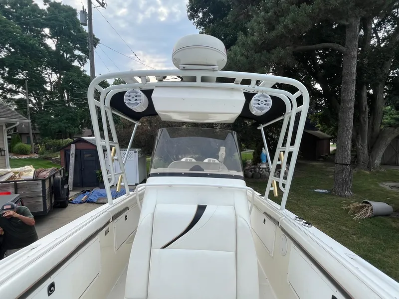 Slide: The Image of 2000 Wellcraft 302 SCARAB SPORT boat with white interior and outdoor setting. - 17