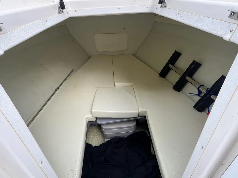 Slide: The Image of Interior cabin of 2000 Wellcraft 302 SCARAB SPORT boat, featuring storage and seating. - 19