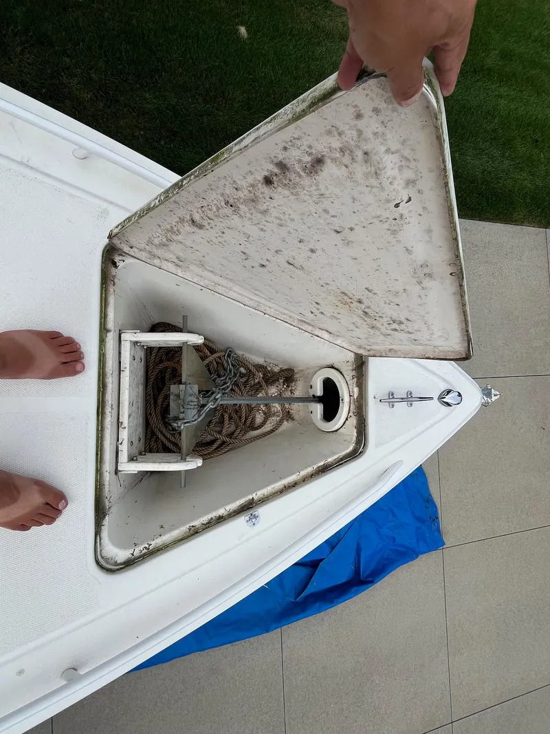 Slide: The Image of Open anchor compartment on 2000 Wellcraft 302 SCARAB SPORT boat, showing rope and chain. - 20